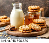 There is fresh milk, oatmeal cookies and honey on the table. Morning breakfast. Still life. Стоковое AI-изображение, AI-художник Сергей Елизарьев / Фотобанк Лори