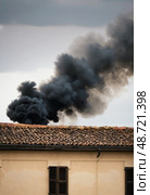A thick plume of black smoke billows from the Sistine Chapel in Vatican City, drawing attention as anticipation builds for a key Church event Generative AI. Стоковое AI-изображение, AI-художник Юлия Петровская / Фотобанк Лори