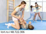 Pair self defense training - two teenage girls doing power grabs. Стоковое фото, фотограф Яков Филимонов / Фотобанк Лори
