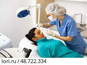 Woman cosmetician giving face injections of botulinum toxin for young woman. Стоковое фото, фотограф Яков Филимонов / Фотобанк Лори