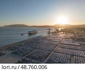New Cars on Parking Lot and RORO cargo ship in Port of Setubal. Aerial View. Стоковое фото, фотограф Максим Забаровский / Фотобанк Лори
