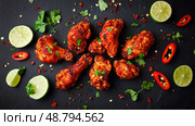table fried chicken on black top view ai generated. Стоковое AI-изображение, AI-художник Vectorwin / Фотобанк Лори