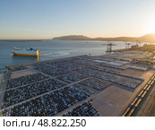 New Cars on Parking Lot and RORO cargo ship in Port of Setubal. Aerial View. Стоковое фото, фотограф Максим Забаровский / Фотобанк Лори