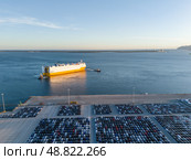 New Cars on Parking Lot and ro-ro Cargo Ship in Port of Setubal. Aerial View. Стоковое фото, фотограф Максим Забаровский / Фотобанк Лори