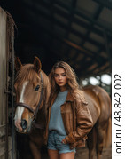 A woman stands in front of a brown horse, wearing a brown jacket and blue jeans. Стоковое AI-изображение, AI-художник Ярославский Максим / Фотобанк Лори