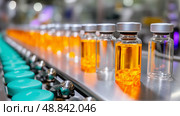 Production of pharmaceutical vials filled with orange liquid at a modern facility in the afternoon. Стоковое AI-изображение, AI-художник Сергей Толмачёв / Фотобанк Лори