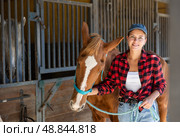 Young woman leads horse out of stable. Стоковое фото, фотограф Яков Филимонов / Фотобанк Лори