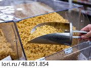 Pasta selection in a grocery store with a scoop for customers to choose their favorite types. Стоковое фото, фотограф Вербицкая Светлана / Фотобанк Лори
