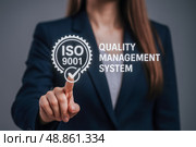 Businesswoman activating ISO 9001 quality management system digital interface with finger, modern corporate certification and compliance assurance concept. Стоковое AI-изображение, AI-художник Павел Муравьев / Фотобанк Лори