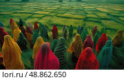 A group of women in colorful saris walk through a field of green crops in India. Стоковое AI-изображение, AI-художник Данила Большаков / Фотобанк Лори