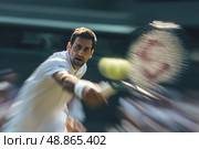 A tennis player is in the middle of a serve, with his racket in the air. Стоковое фото, фотограф Ярославский Максим / Фотобанк Лори