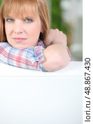 Woman resting her head and arm against a fence. Стоковое фото, агентство Ingram Publishing / Фотобанк Лори