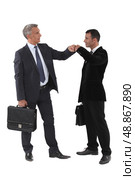 Two businessmen bumping fists. Стоковое фото, агентство Ingram Publishing / Фотобанк Лори