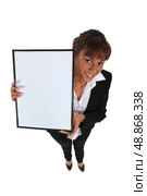 Businesswoman holding up a whiteboard. Стоковое фото, агентство Ingram Publishing / Фотобанк Лори