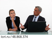 Unimpressed sat with employee. Стоковое фото, агентство Ingram Publishing / Фотобанк Лори