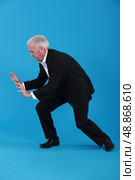 Businessman pushing against empty copyspace. Стоковое фото, агентство Ingram Publishing / Фотобанк Лори