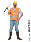 bricklayer holds pickaxe against studio background. Стоковое фото, агентство Ingram Publishing / Фотобанк Лори