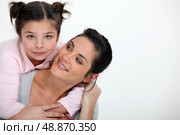 Young girl hugging her mother. Стоковое фото, агентство Ingram Publishing / Фотобанк Лори