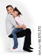 Little girl sat on mother. Стоковое фото, агентство Ingram Publishing / Фотобанк Лори