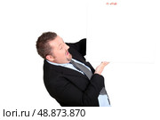 man in a suit holding an empty advertising board. Стоковое фото, агентство Ingram Publishing / Фотобанк Лори