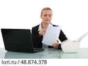 Clerical worker flipping through a document. Стоковое фото, агентство Ingram Publishing / Фотобанк Лори