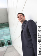 Low angle shot of a businessman outside an office block. Стоковое фото, агентство Ingram Publishing / Фотобанк Лори