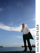 Businessman stood by rivers shipping lane. Стоковое фото, агентство Ingram Publishing / Фотобанк Лори