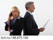 Business professionals standing back to back. Стоковое фото, агентство Ingram Publishing / Фотобанк Лори