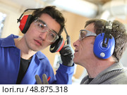 Men wearing ear defenders. Стоковое фото, агентство Ingram Publishing / Фотобанк Лори