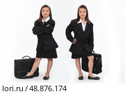 schoolgirls dressed as businesswomen. Стоковое фото, агентство Ingram Publishing / Фотобанк Лори