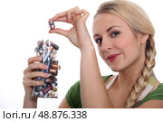Blond woman recycling used batteries. Стоковое фото, агентство Ingram Publishing / Фотобанк Лори