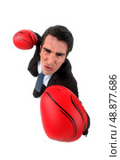 businessman holding boxing gloves looking ferocious. Стоковое фото, агентство Ingram Publishing / Фотобанк Лори