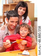 parents and child preparing for Halloween. Стоковое фото, агентство Ingram Publishing / Фотобанк Лори
