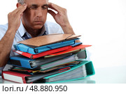 Man with stack of work. Стоковое фото, агентство Ingram Publishing / Фотобанк Лори