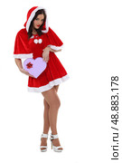 Sexy woman dressed as Mrs Claus with a heart-shaped box. Стоковое фото, агентство Ingram Publishing / Фотобанк Лори