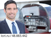 man standing in front of a plane cockpit. Стоковое фото, агентство Ingram Publishing / Фотобанк Лори
