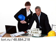 Architect and colleagues preparing business proposal. Стоковое фото, агентство Ingram Publishing / Фотобанк Лори
