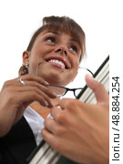 Low-angle shot of a woman carrying a file. Стоковое фото, агентство Ingram Publishing / Фотобанк Лори