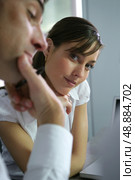 brunette and companion sitting together at desk. Стоковое фото, агентство Ingram Publishing / Фотобанк Лори