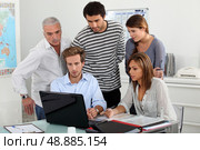 Trainees looking at a laptop. Стоковое фото, агентство Ingram Publishing / Фотобанк Лори