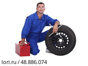 mechanic changing a tire. Стоковое фото, агентство Ingram Publishing / Фотобанк Лори
