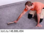 Man renovating the floor. Стоковое фото, агентство Ingram Publishing / Фотобанк Лори