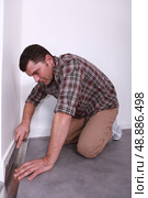 portrait of a man laying linoleum. Стоковое фото, агентство Ingram Publishing / Фотобанк Лори