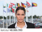 Brunette stood by flags. Стоковое фото, агентство Ingram Publishing / Фотобанк Лори