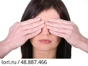 Woman covering face with hands. Стоковое фото, агентство Ingram Publishing / Фотобанк Лори