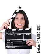 woman using movie clap. Стоковое фото, агентство Ingram Publishing / Фотобанк Лори