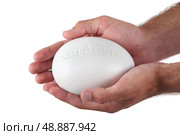Hands holding a stone marked ’serenite’ Стоковое фото, агентство Ingram Publishing / Фотобанк Лори