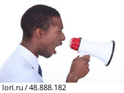 Side view of a man shouting into a megaphone. Стоковое фото, агентство Ingram Publishing / Фотобанк Лори