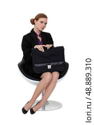 Shy applicant waiting in an armchair. Стоковое фото, агентство Ingram Publishing / Фотобанк Лори