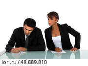 Woman copying on her workmate. Стоковое фото, агентство Ingram Publishing / Фотобанк Лори